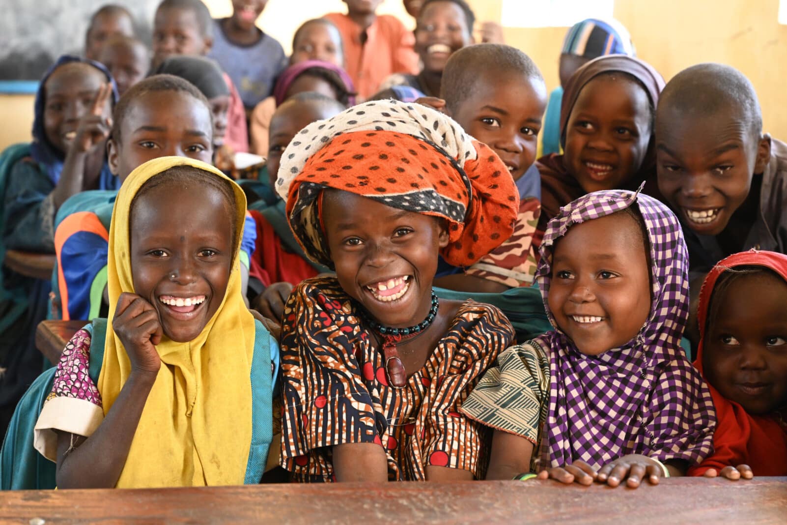 Group of African children in school uniforms studying in a classroom