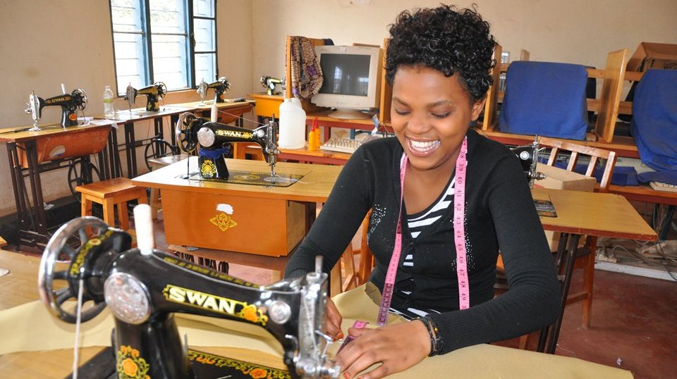 Young adults learning carpentry skills in a vocational training workshop